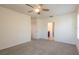 Bedroom with carpet, ceiling fan, and access to a bathroom at 16810 Trite Bend St, Wimauma, FL 33598
