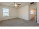 Bedroom with carpet, ceiling fan, and a window at 16810 Trite Bend St, Wimauma, FL 33598