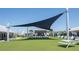 Outdoor community green space with shade and seating at 16810 Trite Bend St, Wimauma, FL 33598