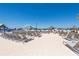 Lounge chairs sit on the beach by the lagoon at 16810 Trite Bend St, Wimauma, FL 33598