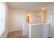 Bright upstairs hallway with white trim, neutral walls, and a view into the bathroom at 16810 Trite Bend St, Wimauma, FL 33598