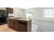 Well-equipped kitchen with granite countertops and adjacent living area at 16810 Trite Bend St, Wimauma, FL 33598