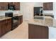 Modern kitchen with granite countertops and stainless steel appliances at 16810 Trite Bend St, Wimauma, FL 33598