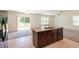 Modern kitchen featuring a granite island, stainless steel appliances, and an open layout to the living area at 16810 Trite Bend St, Wimauma, FL 33598