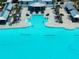 Aerial view of aqua lagoon featuring a swim up bar, sandy beach, and community center at 16810 Trite Bend St, Wimauma, FL 33598