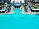 Aerial view of aqua lagoon featuring a swim up bar, sandy beach, and community center at 16810 Trite Bend St, Wimauma, FL 33598