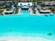 Aerial view of aqua lagoon featuring a swim up bar, sandy beach, and community center at 16810 Trite Bend St, Wimauma, FL 33598