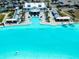 Aerial view of aqua lagoon featuring a swim up bar, sandy beach, and community center at 16810 Trite Bend St, Wimauma, FL 33598