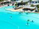 Aerial view of aqua lagoon featuring paddle boarding, kayaking, cabana lounge areas, and sandy beach at 16810 Trite Bend St, Wimauma, FL 33598