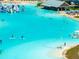 Beautiful lagoon view with paddle boarders, lounge chairs and a bar for fun in the sun at 16810 Trite Bend St, Wimauma, FL 33598