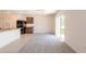 Open-concept living space featuring tile flooring, dark cabinets, and sliding glass doors at 16810 Trite Bend St, Wimauma, FL 33598