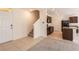 Inviting entryway leads to an open floor plan featuring tile and carpet flooring and a staircase at 16810 Trite Bend St, Wimauma, FL 33598
