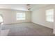 Spacious living area with plush carpet flooring, lots of natural light, and an open concept design at 16810 Trite Bend St, Wimauma, FL 33598