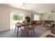 Bright living room with sliding glass door, comfortable sofa, and dining area at 16810 Trite Bend St, Wimauma, FL 33598