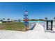 Community signage indicates directions to the Splash Pad, Cabana Cove, Lagoon Bar, Bandshell, Registration, and Restrooms at 16810 Trite Bend St, Wimauma, FL 33598