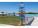 Community signage indicates directions to the Splash Pad, Cabana Cove, Lagoon Bar, Bandshell, Registration, and Restrooms at 16810 Trite Bend St, Wimauma, FL 33598