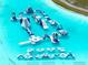 Aerial view of a large water park with a floating obstacle course for adventurous aquatic recreation at 16810 Trite Bend St, Wimauma, FL 33598