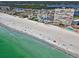 Aerial view of a pristine beach and coastline with three high-rise condo buildings along the Gulf of Mexico at 17940 Gulf Blvd # 9B, Redington Shores, FL 33708
