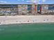 Three high-rise condos sit on a pristine beach with turquoise water under a sunny, blue sky at 17940 Gulf Blvd # 9B, Redington Shores, FL 33708