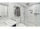 Modern bathroom featuring a glass shower, marble tile, and towel warmer at 17940 Gulf Blvd # 9B, Redington Shores, FL 33708