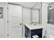 Chic bathroom featuring marble wall, vanity with drawers, and bright lighting at 17940 Gulf Blvd # 9B, Redington Shores, FL 33708