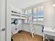 Bright bedroom features a bunk bed, desk, and a shuttered window at 17940 Gulf Blvd # 9B, Redington Shores, FL 33708