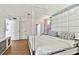 A cozy bedroom offers a modern design with herringbone floors and an ensuite bathroom at 17940 Gulf Blvd # 9B, Redington Shores, FL 33708