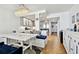 Dining area with chandelier and direct view of the fully renovated kitchen at 17940 Gulf Blvd # 9B, Redington Shores, FL 33708