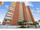 A low angle view of a high rise residential condo building with balconies under a blue sky at 17940 Gulf Blvd # 9B, Redington Shores, FL 33708