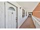 Hallway view with white exterior door and view down a long hallway at 17940 Gulf Blvd # 9B, Redington Shores, FL 33708