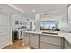 Open-concept kitchen with light gray cabinets, quartz counters, and a view of the living area at 17940 Gulf Blvd # 9B, Redington Shores, FL 33708