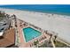 Aerial view of a sparkling pool with abundant lounge chairs, offering resort-style living at 17940 Gulf Blvd # 9B, Redington Shores, FL 33708