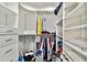 Organized walk-in closet with drawers, shelves and hanging rods, provides ample storage at 17940 Gulf Blvd # 9B, Redington Shores, FL 33708
