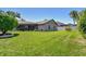 Spacious, manicured backyard with lush grass, white fencing, and mature landscaping at 18533 Avocet Dr, Lutz, FL 33558