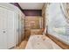 Bright bathroom features a soaking tub, separate shower with glass door and tile surround at 18533 Avocet Dr, Lutz, FL 33558