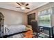 Bedroom with ceiling fan, hardwood floors, desk and chair, and a blackboard for personalization at 18533 Avocet Dr, Lutz, FL 33558