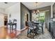 Dining area with stylish chandelier, hardwood floors, and access to the screened lanai at 18533 Avocet Dr, Lutz, FL 33558
