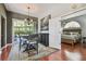 Dining area with hardwood floors, modern chandelier, and an open view to the main bedroom at 18533 Avocet Dr, Lutz, FL 33558
