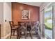 Dining area with modern table and chairs, accented by a warm-toned wall and patio door at 18533 Avocet Dr, Lutz, FL 33558