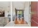 Inviting entryway featuring hardwood floors, decorative columns, and views of the dining room at 18533 Avocet Dr, Lutz, FL 33558