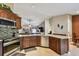 Well-lit kitchen features stainless steel appliances, granite countertops, tile backsplash, and wooden cabinets at 18533 Avocet Dr, Lutz, FL 33558
