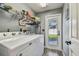 Laundry room featuring washer, dryer, wire shelving, and access to the backyard at 18533 Avocet Dr, Lutz, FL 33558