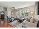 Cozy living room featuring hardwood floors, stylish furniture, and lots of natural light at 18533 Avocet Dr, Lutz, FL 33558