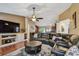 Comfortable living room with a large sectional sofa, entertainment center, and hardwood floors at 18533 Avocet Dr, Lutz, FL 33558