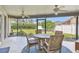 Screened patio with ceiling fans, outdoor seating and views of the backyard at 18533 Avocet Dr, Lutz, FL 33558