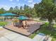 Community playground with slides, swings, and play area covered with safety mulch at 18533 Avocet Dr, Lutz, FL 33558
