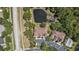 Overhead view of townhomes with parking, pool, and pond access, situated next to a road and lush trees at 18981 Duquesne Dr, Tampa, FL 33647