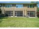 Back of home features screened patios and a well-maintained lawn at 18981 Duquesne Dr, Tampa, FL 33647