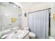 Bathroom with a single vanity and mirror, toilet, and bathtub with a shower curtain at 18981 Duquesne Dr, Tampa, FL 33647