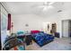 Bright bedroom featuring an open floor plan, study area, a ceiling fan and wall decor at 18981 Duquesne Dr, Tampa, FL 33647